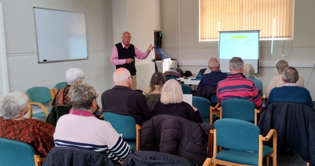 Image of the DNA group members meeting during a talk by the Convenor