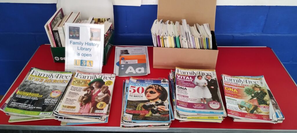 Ringmer u3a family history group library table with books and magazines on top